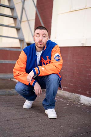 dj-mad-max-kneeling-near-stairs-about-page-image